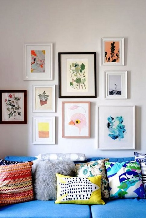 4. Colorful throw pillows on a blue sofa via Apartment Therapy