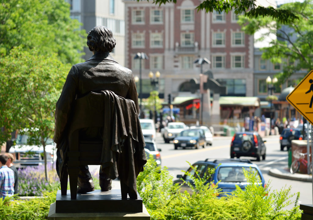 a view of harvard square and a statue