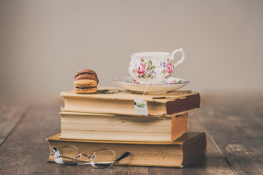 stacked books with a teacup on top