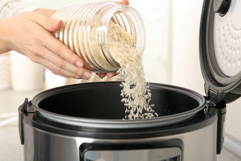 pouring rice into a pressure cooker