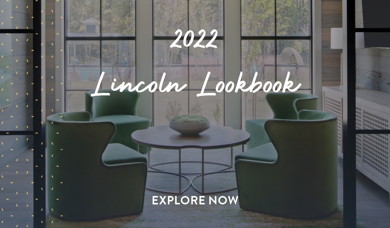 a seating area with two chairs and a table in front of beautiful floor to ceiling windows | Lincoln Property Company 2022 Lookbook