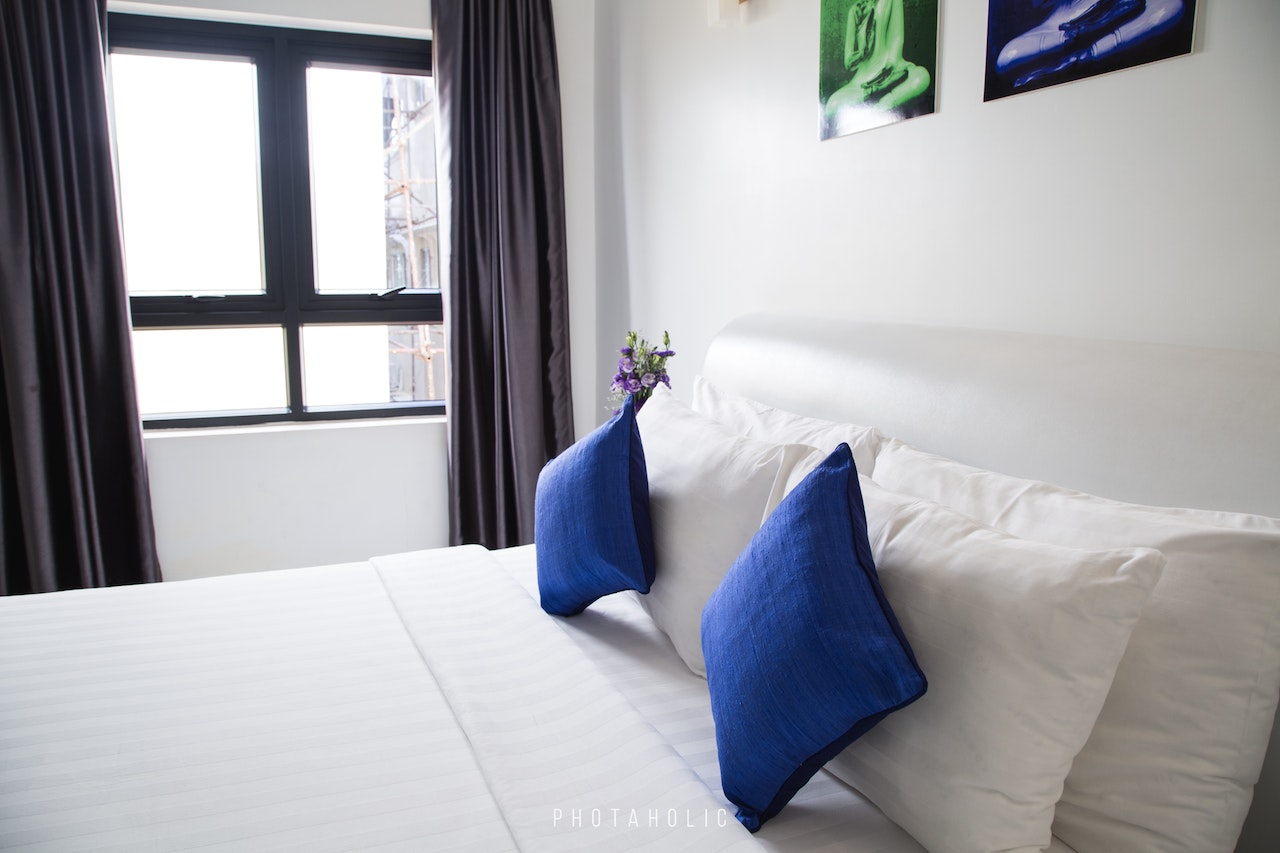 a bed with blue pillows | bed upgrades