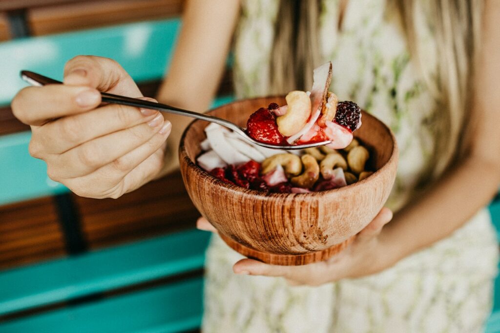 person holding a spoonful of an acai bowl | energizing lunch recipes