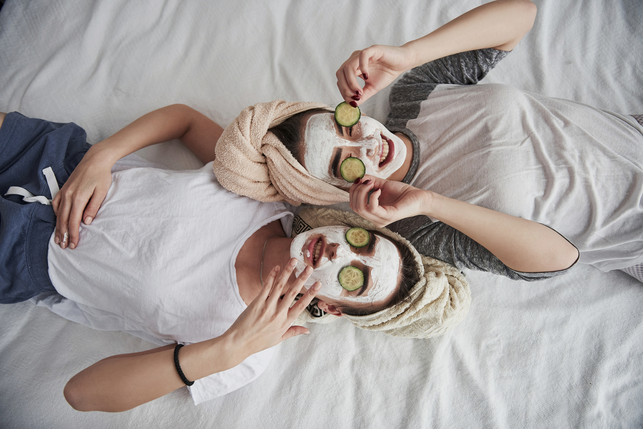 friend relaxing with cucumber on eyes and in face masks | how to turn apartment into a spa